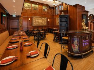 a restaurant with wooden walls and tables and chairs at Park Hotel Condominiums in Park City