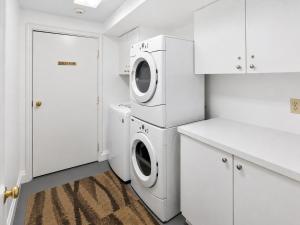 a white laundry room with a washer and dryer at Park Hotel Condominiums in Park City
