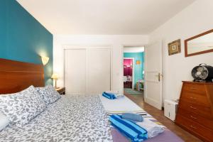 a bedroom with a large bed with blue walls at The Colors House, 639 Private Apartment in Costa Teguise