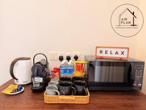 a kitchen counter with a microwave and a tray with water bottles at PD Full Seaview Water Chalet with Private Bathtub in Port Dickson