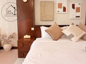 a bedroom with a bed with white sheets and pillows at PD Full Seaview Water Chalet with Private Bathtub in Port Dickson