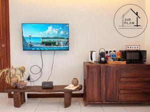 a living room with a flat screen tv on a wall at PD Full Seaview Water Chalet with Private Bathtub in Port Dickson