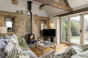 a living room with a couch and a fireplace at Perry Cottage in Halford