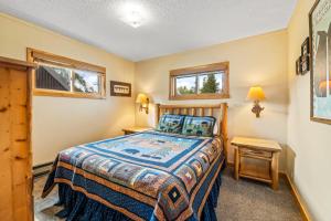 a bedroom with a bed and a table and two windows at Hiker in Clark +22 photos