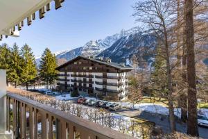 a balcony view of a hotel with mountains in the background at Le Brevent apartment -Chamonix All Year in Chamonix-Mont-Blanc