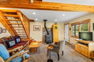 a living room with a staircase and a fireplace at Hiker in Clark