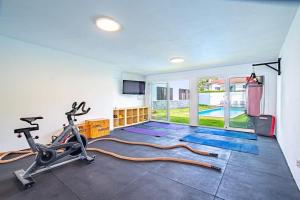 a fitness room with a gym with a treadmill and a treadmill at Portugal Active Cabedelo Beach Lodge - Heated Pool in Viana do Castelo