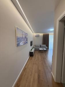 a living room with a couch and a television at Almare ApartHotel in Golem