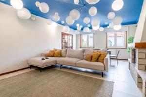 a living room with a couch and a blue ceiling at Portugal Active Cabedelo Beach Lodge - Heated Pool in Viana do Castelo +81 photos