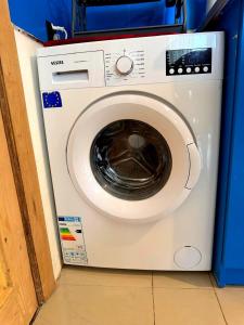 a white washing machine sitting in a room at Tbilisi Vake Inn in Tbilisi City