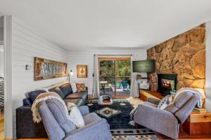 a living room with couches and a stone wall at Wintersong in Clark