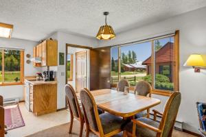 a kitchen and dining room with a wooden table and chairs at Wood Duck in Clark