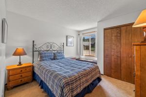 a bedroom with a bed and a dresser and a window at Wood Duck in Clark