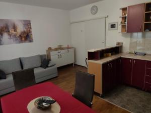a kitchen and a living room with a couch and a table at My Way in Beograd