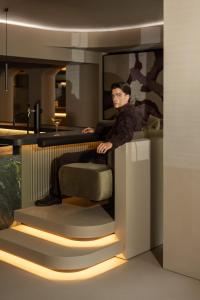 a man sitting in a chair in a room at Gourmet & Wine Hotel Austria - 4 Sterne superior - Hike & Bike in Obergurgl