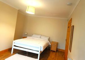 a bedroom with a white bed in a room at Ideal Guest Home in Waterford