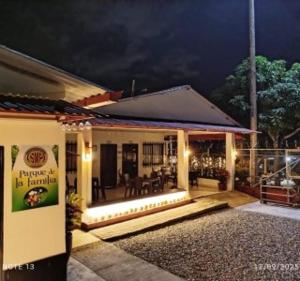 a house with a porch with lights on it at Parque de la Familia in Montenegro