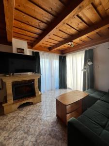a living room with a couch and a fireplace at Sziget Apartman Fonyód in Fonyód