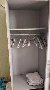 a closet filled with lots of white hangers at Chambre Simple avec parking gratuit in Bourges