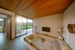 a living room with a couch and a tv at Casa Ariana in Ubud