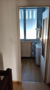 an open door to a kitchen with a window at Chambre Simple avec parking gratuit in Bourges