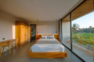 a bedroom with a bed and a large window at Casa Ariana in Ubud +45 photos