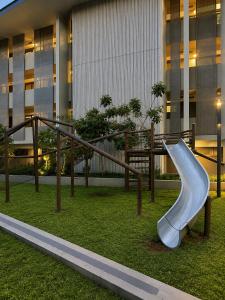 a slide in a park in front of a building at Ocean Dunes Bachelor Apartments in Umhlanga