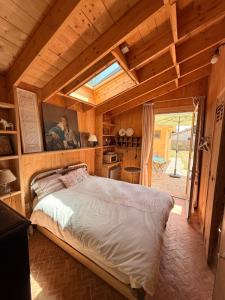 a bedroom with a large bed in a wooden house at beachhousebarn in Vendays-Montalivet +18 photos