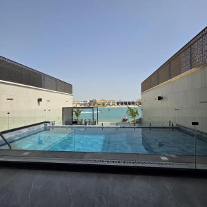 a large swimming pool in the middle of a building at ViLora VILA in Durat Alarous