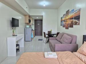a living room with a couch and a table at CozyNest Rentals at Brenthill Condominium in Baguio +16 photos