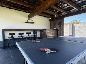 a ping pong table in a room with a ping pong racket at Sarajevo Villa Sunce in Ilijaš