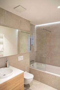 a bathroom with a sink and a toilet and a shower at REGENTova SUITES Ljubljana in Ljubljana +92 photos