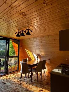 a dining room with a table and chairs at khedi cottage in Mestia