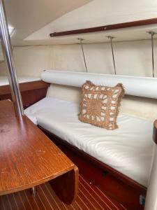 a bed on the back of a boat with a pillow at The Happy Sailor in Viana do Castelo