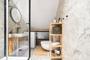 a bathroom with a white toilet and a sink at Tago Forest - Dune Apartments in Jūrmalciems +56 photos