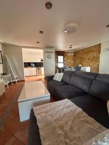 a large living room with a couch and a kitchen at Chalet Los angeles torrevieja in Torrevieja +11 photos