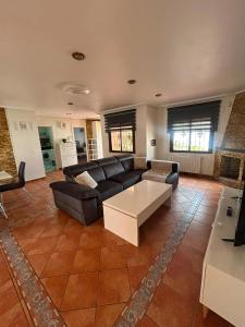 a living room with a couch and a coffee table at Chalet Los angeles torrevieja in Torrevieja