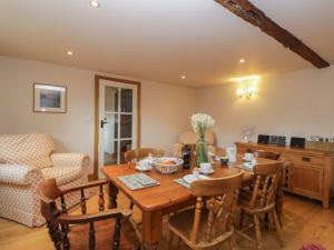 a dining room with a wooden table and chairs at The Old Barn in Hereford +34 photos