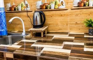 a kitchen with a sink and a coffee pot on a counter at RK guest in Nanu Oya