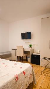 a hotel room with a desk and a bed at Real Rooms in La Spezia +33 photos