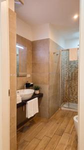 a bathroom with a sink and a shower at Real Rooms in La Spezia