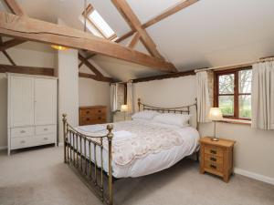 a bedroom with a large bed and a window at The Granary in Hereford