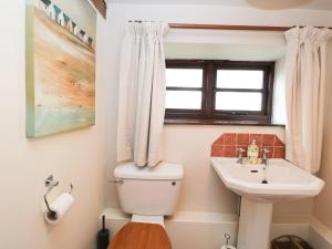 a bathroom with a toilet and a sink and a window at The Granary in Hereford +27 photos