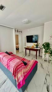 a bedroom with a bed and a table and a tv at Miramare in Crotone