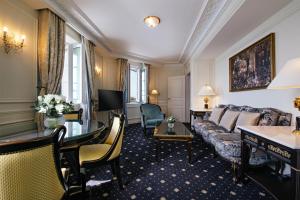 a hotel room with a couch and a table at Hôtel du Palais Biarritz, in The Unbound Collection by Hyatt in Biarritz