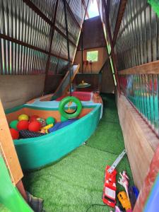 a toy boat is inside of a play house at Nirvana bamboo houses & dive centre in Moalboal +104 photos