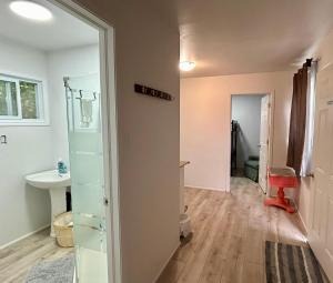 a room with a bathroom with a sink and a mirror at Chicken Shack Motel in Batchawana +11 photos