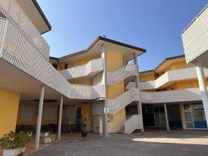 an apartment building with stairs on the side of it at Condominio Canaima in Bibione