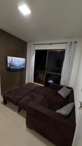 a bedroom with a large bed and a window at Flat Beira mar in Cabo de Santo Agostinho