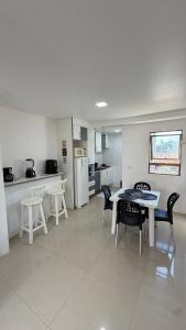 a kitchen and dining room with a table and chairs at Flat Beira mar in Cabo de Santo Agostinho